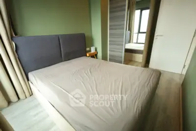 Cozy bedroom with modern design and ample natural light, featuring a stylish bed and mirrored wardrobe.