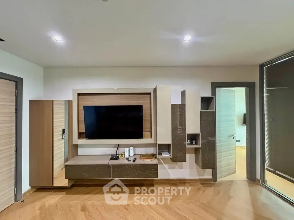 Modern living room with sleek TV unit and wooden flooring