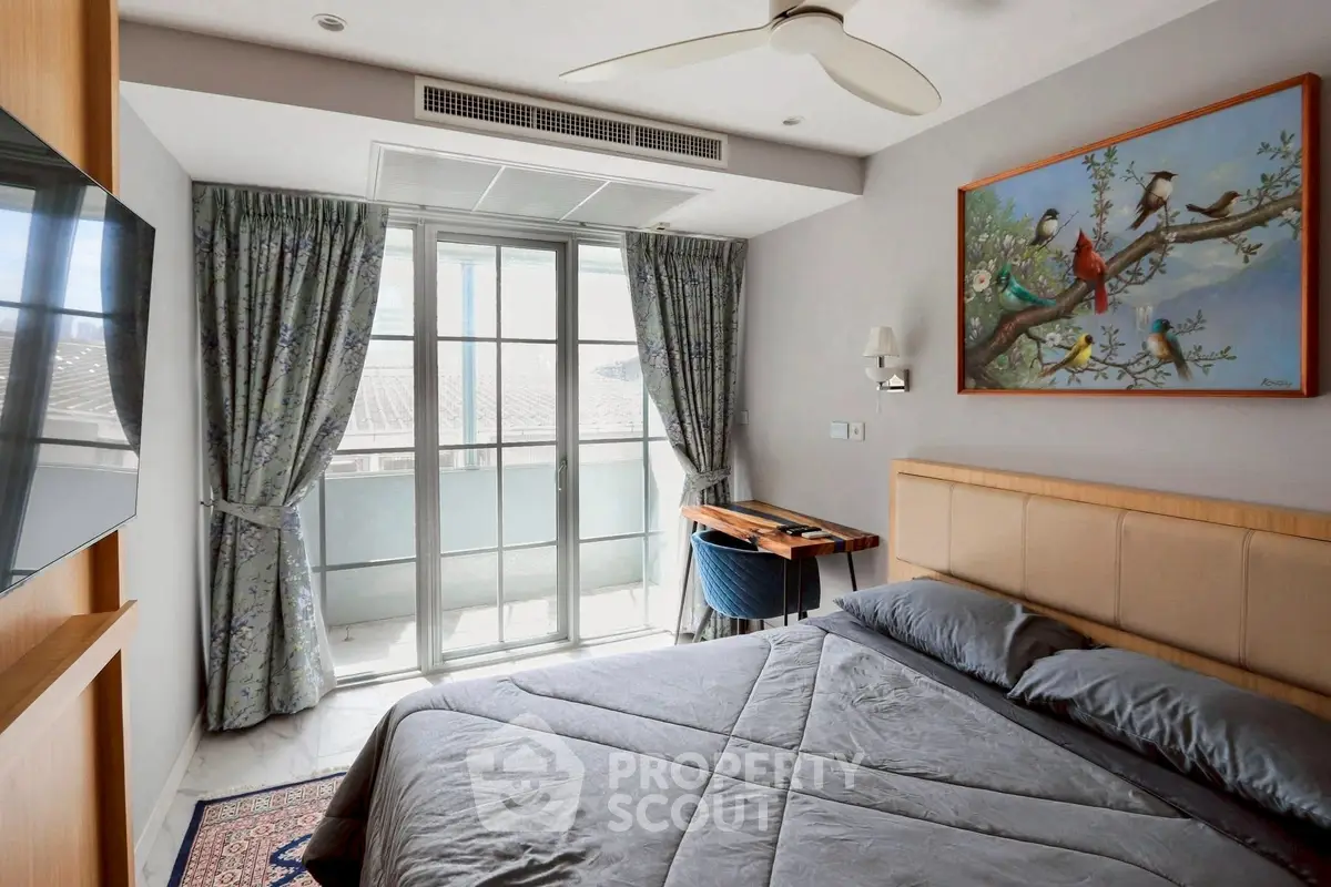 Modern bedroom with balcony access and stylish decor, featuring a cozy bed and elegant curtains.