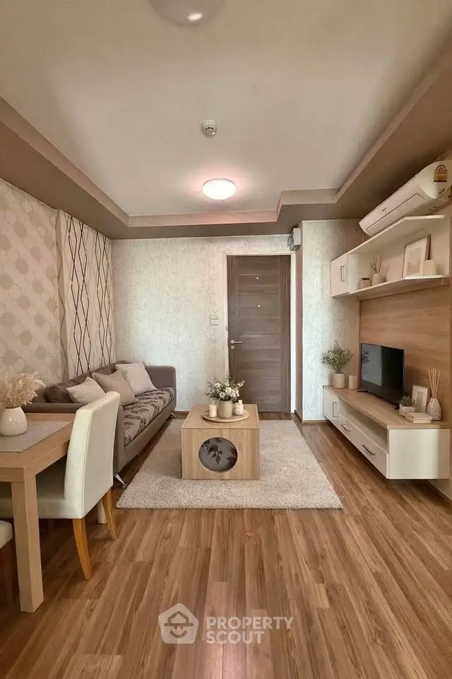 Stylish living room with modern decor, wooden flooring, and cozy seating area.