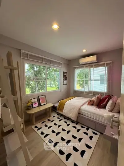 Cozy bedroom with large windows and modern decor, perfect for relaxation.