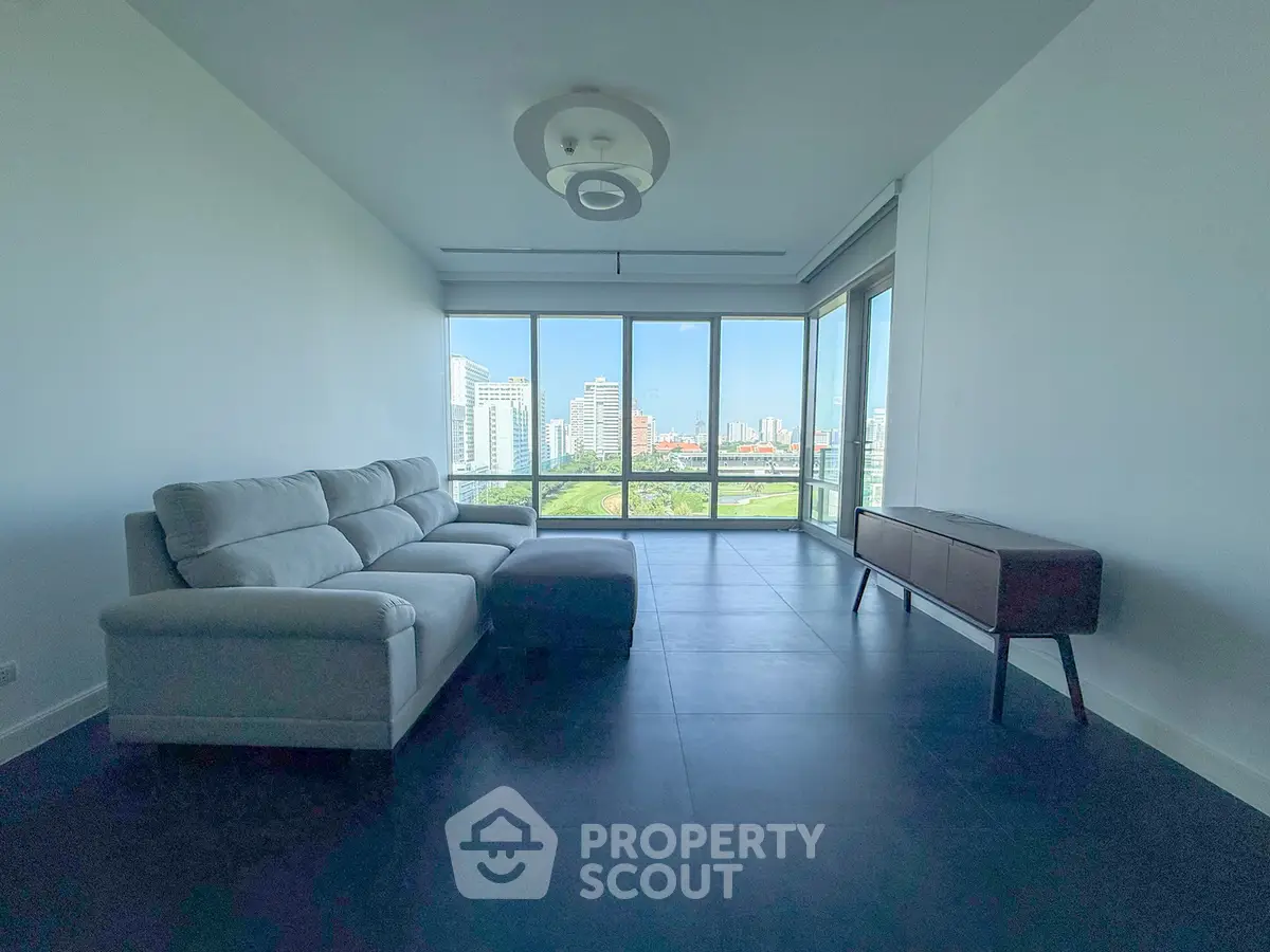 Spacious living room with panoramic city view and modern furniture