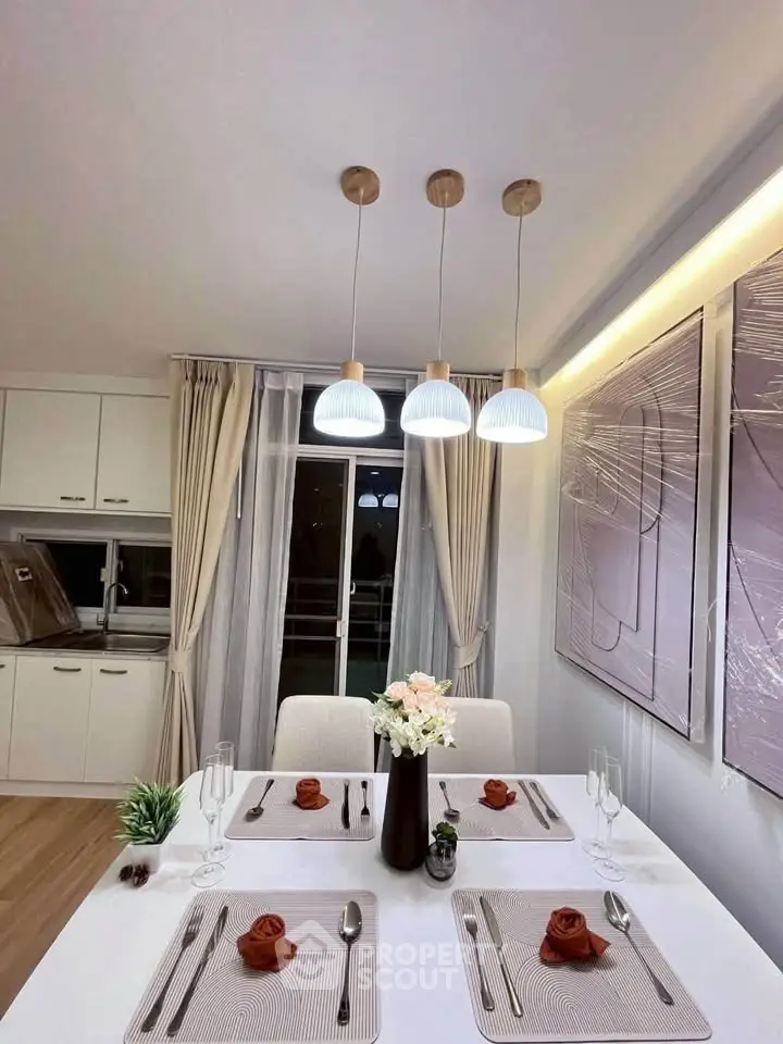 Elegant dining area with modern lighting and stylish decor in a contemporary apartment.