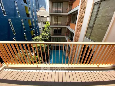 Modern apartment balcony with pool view and stylish architecture