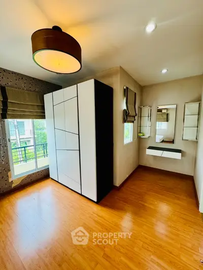 Spacious bedroom with modern wardrobe and natural light