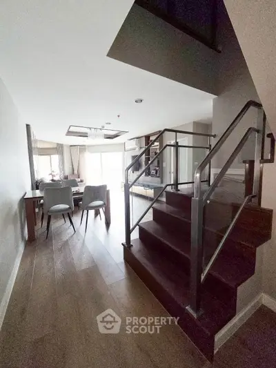 Modern duplex apartment with stylish staircase and open living area