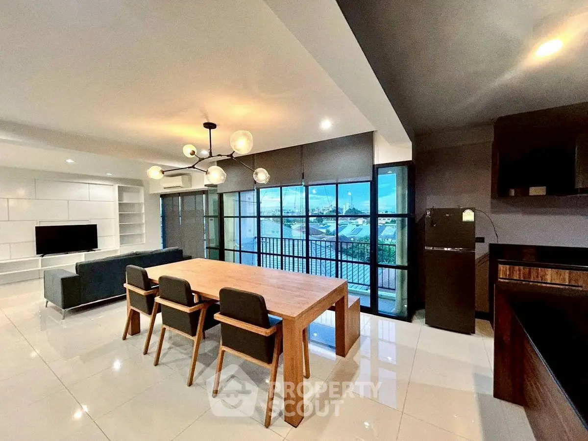 Spacious modern living room with dining area and large windows offering stunning views.
