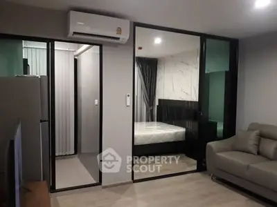 Modern apartment interior with glass partition, air conditioning, and stylish decor.