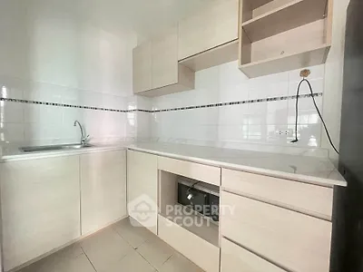 Modern kitchen with sleek cabinetry and built-in microwave