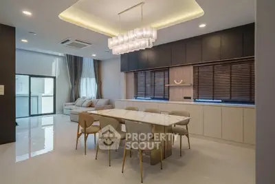 Luxurious modern dining area with elegant lighting and spacious seating in a contemporary home.