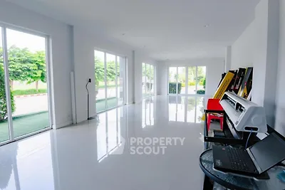 Spacious modern living room with large windows and glossy white flooring