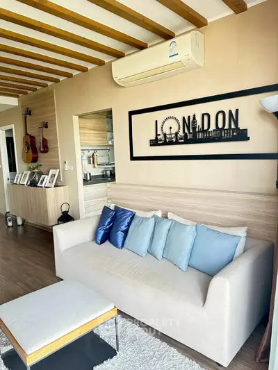 Stylish living room with modern decor and cozy seating in a contemporary apartment.
