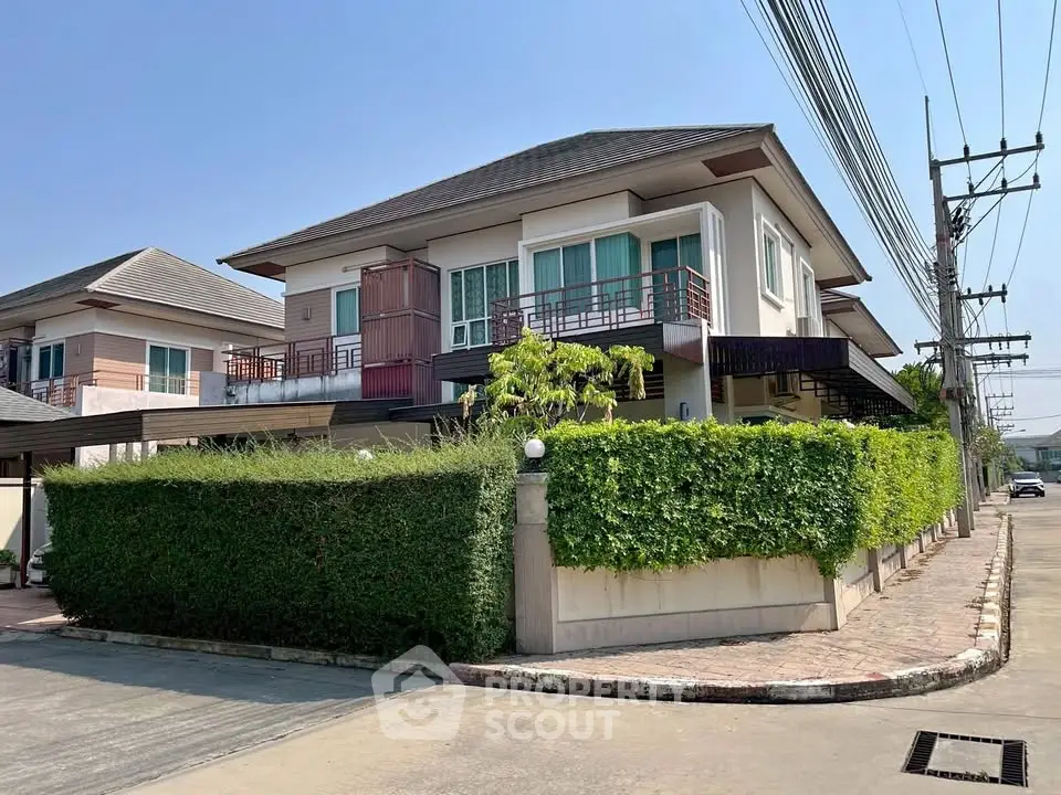 Modern two-story house with lush greenery and spacious corner lot in a serene neighborhood.