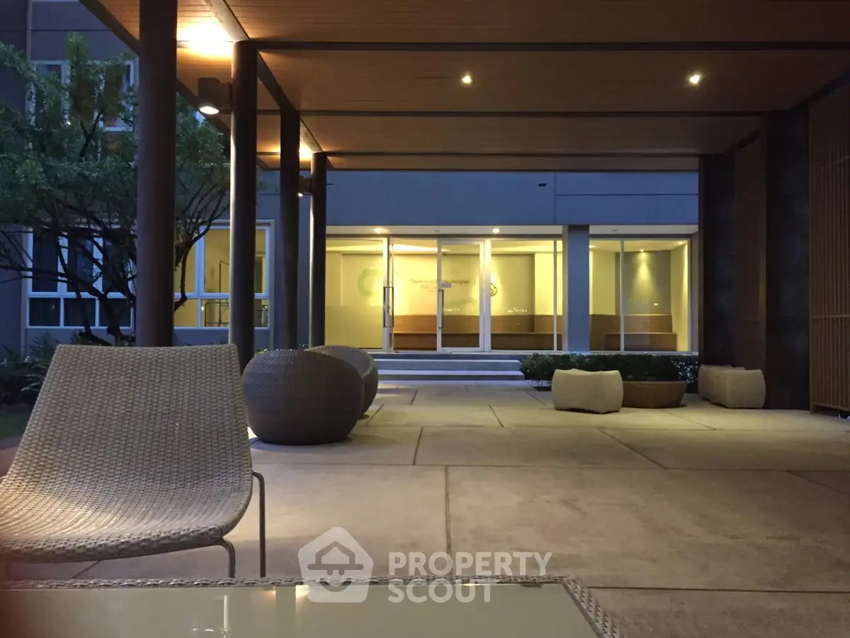 Elegant building entrance with modern seating and ambient lighting