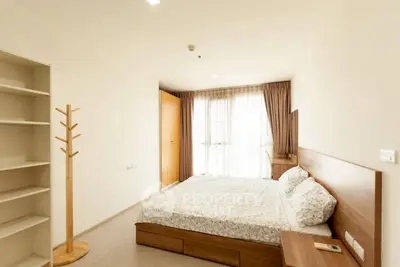 Spacious bedroom with modern furnishings and ample natural light