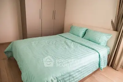 Cozy bedroom with modern wardrobe and stylish bedding in a serene setting.