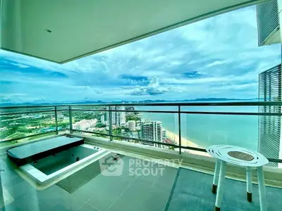 Luxurious high-rise balcony with stunning ocean view and private jacuzzi, perfect for relaxation and entertainment.