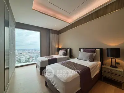 Luxurious twin bedroom with stunning city view from large window, elegant decor and ambient lighting.