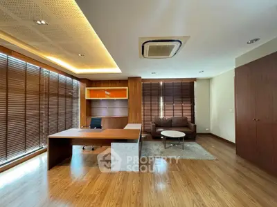 Spacious modern study with wooden flooring and stylish furniture