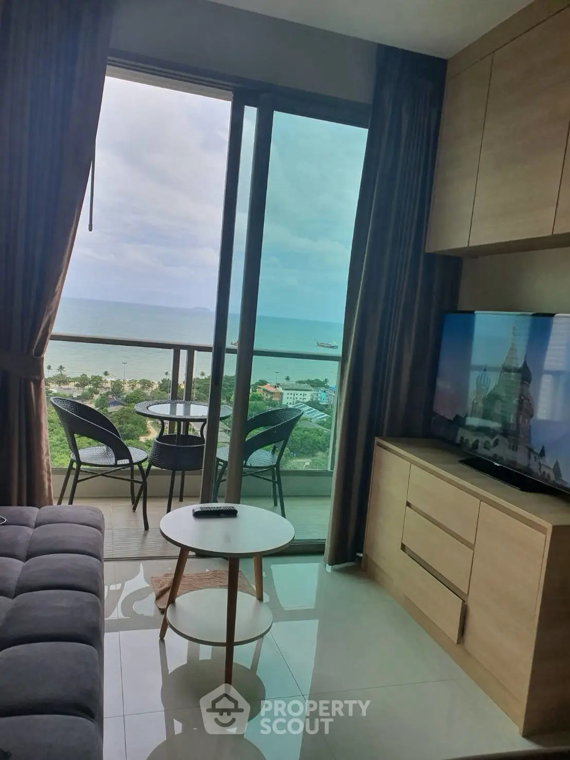 Stunning living room with ocean view balcony in modern apartment