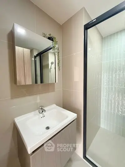 Modern bathroom with sleek sink and glass shower enclosure