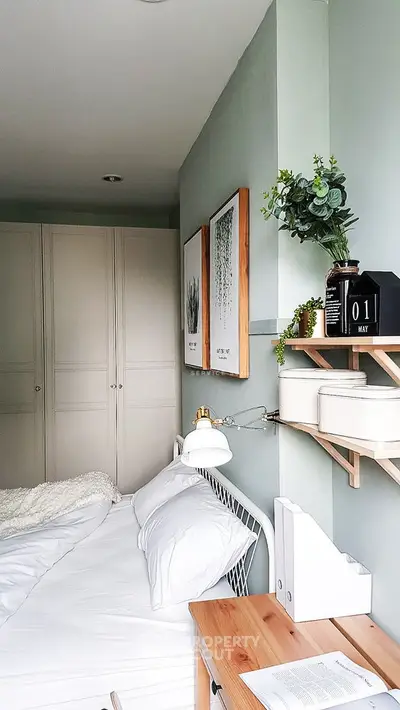 Cozy bedroom with modern decor, featuring a comfortable bed, stylish artwork, and ample storage space.