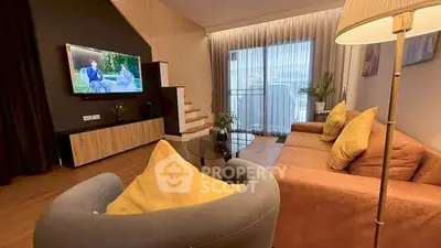 Spacious living room with modern decor and large windows for natural light.