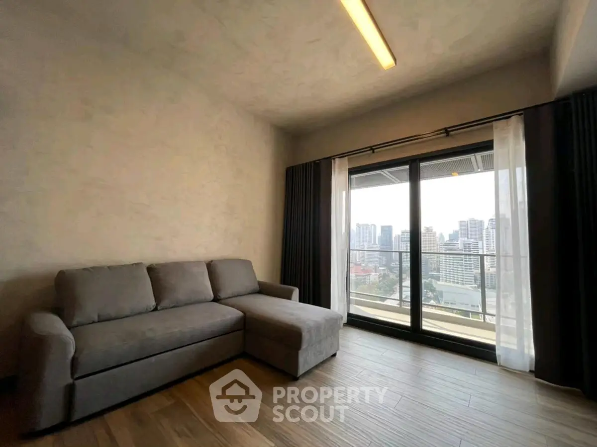 Modern living room with city view and cozy gray sofa