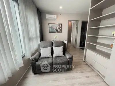 Modern living room with cozy seating and stylish decor in a bright apartment.