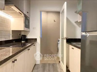 Modern kitchen with sleek countertops and built-in appliances, featuring a closed layout design.
