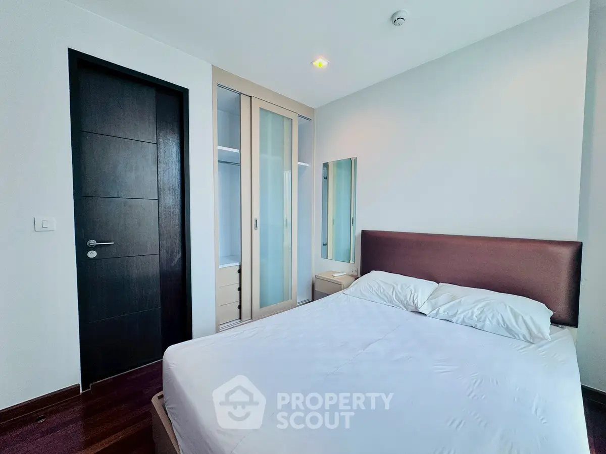 Modern bedroom with sleek design and ample storage space