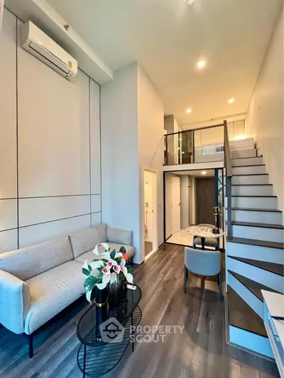 Modern duplex living room with stylish furniture and elegant staircase