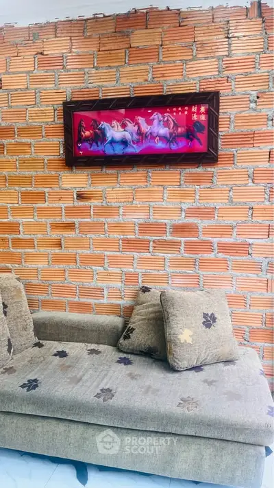 Cozy living room with exposed brick wall and comfortable sofa, perfect for relaxation.