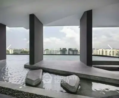 Stunning modern building exterior with water feature and panoramic city views.