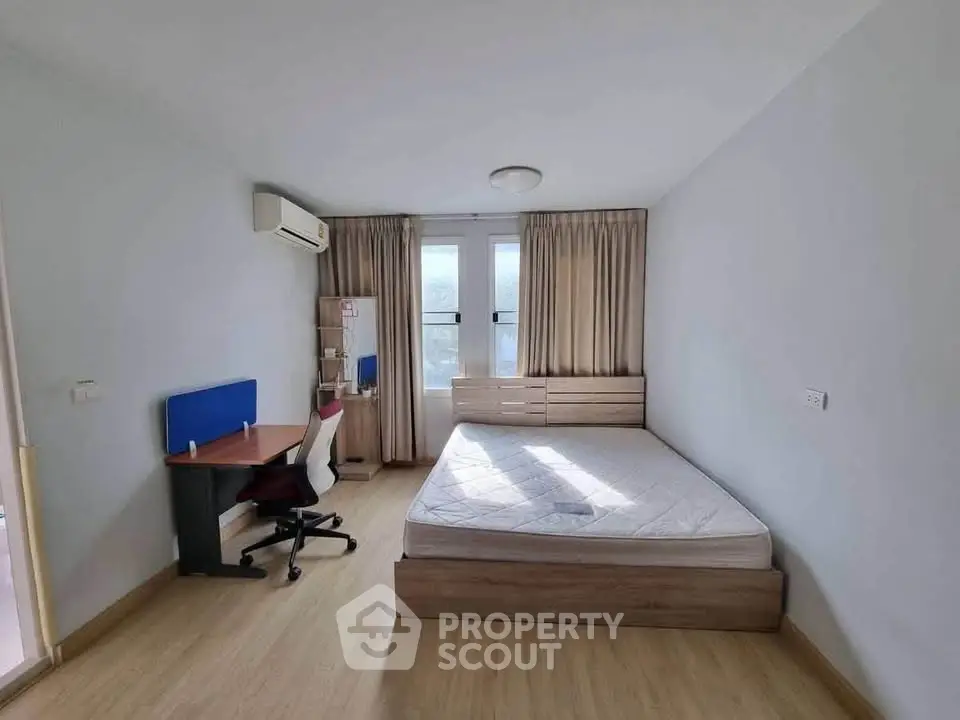 Spacious bedroom with modern furniture and natural light