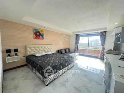 Spacious bedroom with modern decor and balcony view in urban apartment