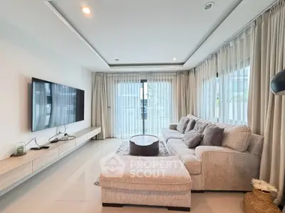 Spacious modern living room with large windows and elegant furnishings