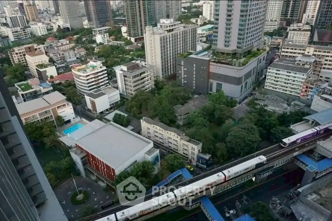 Stunning aerial view of urban skyline with modern high-rise buildings and lush greenery, perfect for city living.
