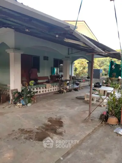 Charming single-story home with spacious front yard and covered patio, perfect for outdoor relaxation.