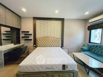 Luxurious bedroom with elegant decor and plush furnishings, featuring a stylish bed and modern amenities.