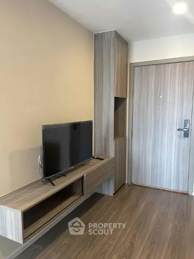 Modern living room with sleek wooden flooring and stylish TV unit