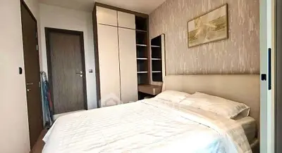 Modern bedroom with stylish decor and ample storage in a cozy apartment.