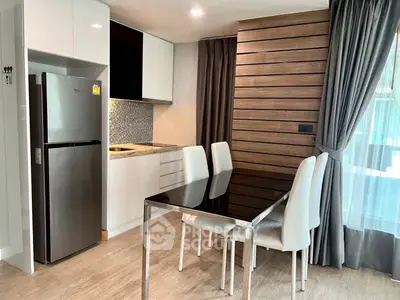Modern kitchen with sleek dining area and stainless steel appliances