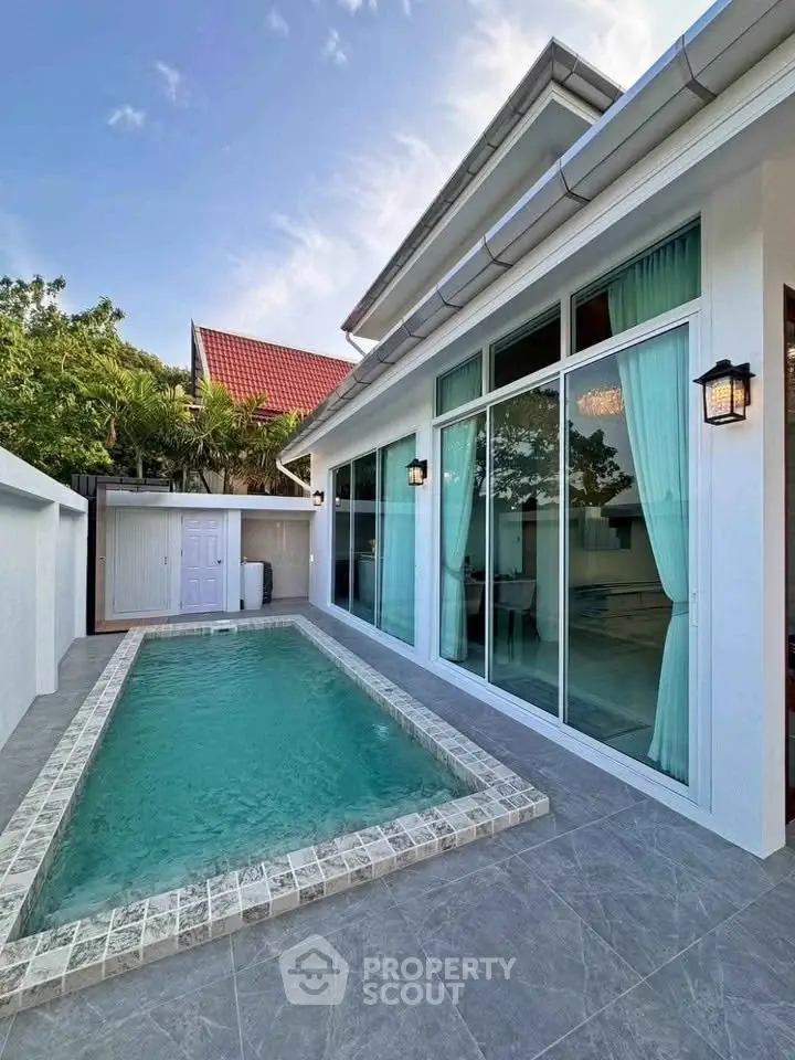 Luxurious modern villa with private pool and elegant glass facade, perfect for serene living.