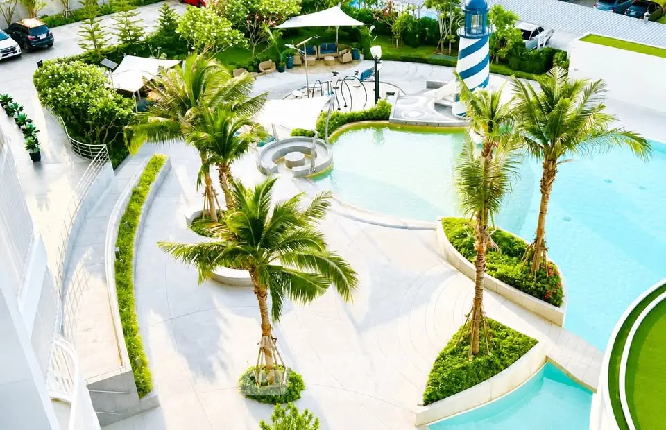 Luxurious outdoor pool area with lush greenery and modern design, perfect for relaxation and leisure.