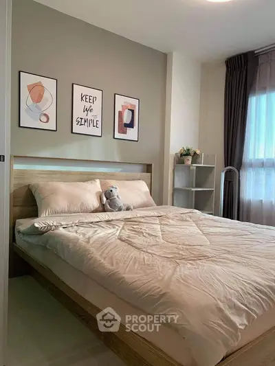 Cozy bedroom with modern decor and natural light, featuring a plush bed and stylish wall art.