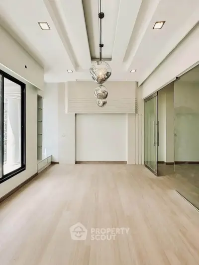 Spacious modern living room with elegant lighting and large windows