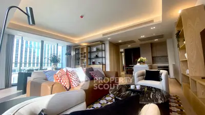 Luxurious modern living room with open kitchen and stylish decor in high-rise apartment.