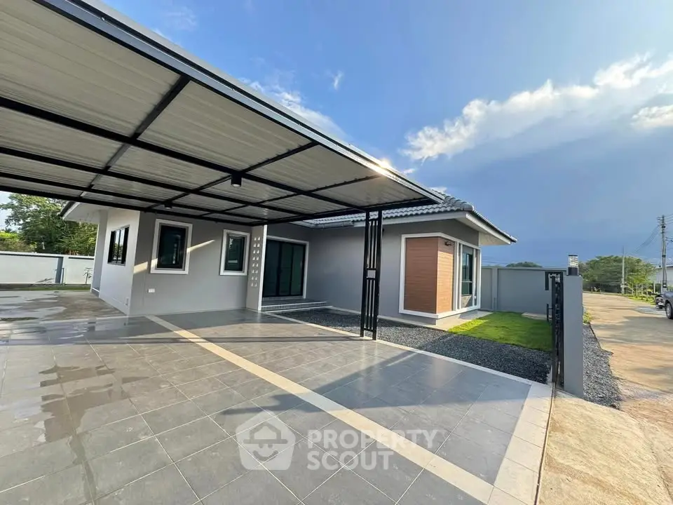 Modern single-story home with spacious carport and sleek exterior design.