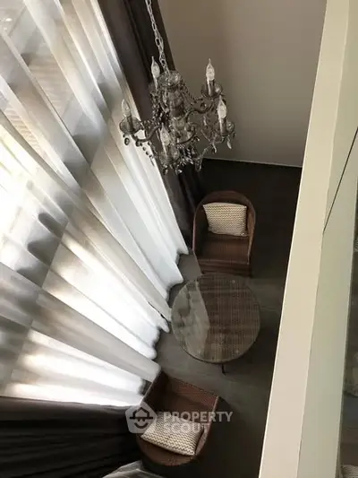 Elegant loft view with chandelier and cozy seating area